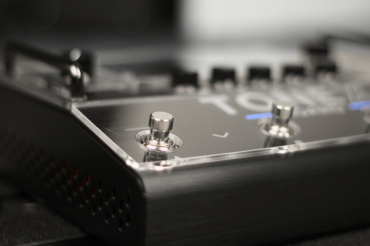 Close-up of the clear acrylic shield on the TONEX Board, with the footswitches left free