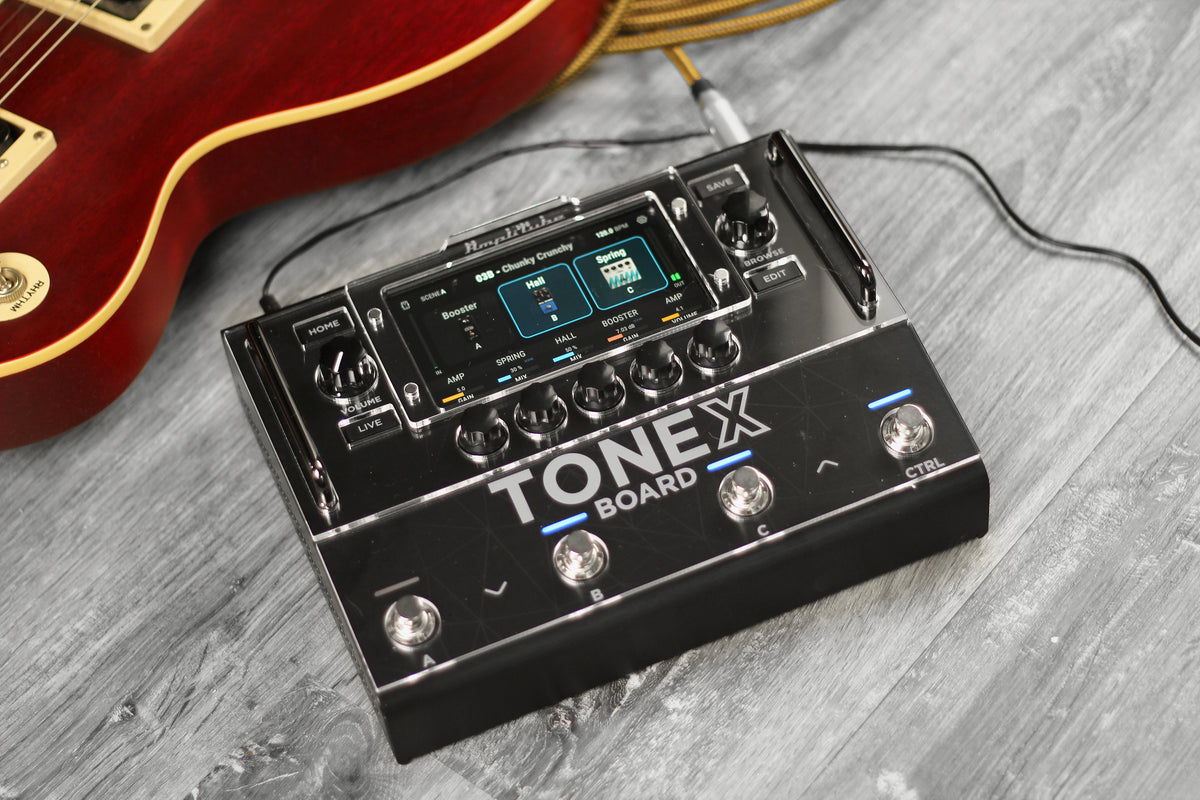 IK Multimedia TONEX Board with ProtectYourGear acrylic shield next to an electric guitar