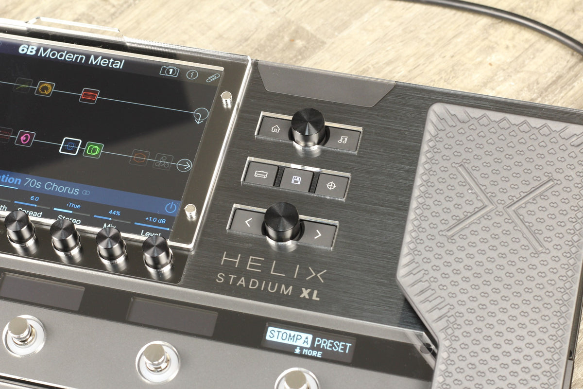 Close-up of the Line 6 Helix Stadium XL with the acrylic shield over the display, next to the controls and the expression pedal