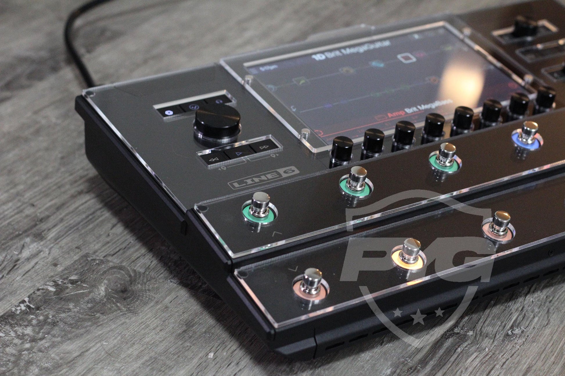 Line 6 Helix Stadium powered on with a preset on screen, the display clearly readable through the clear acrylic protector