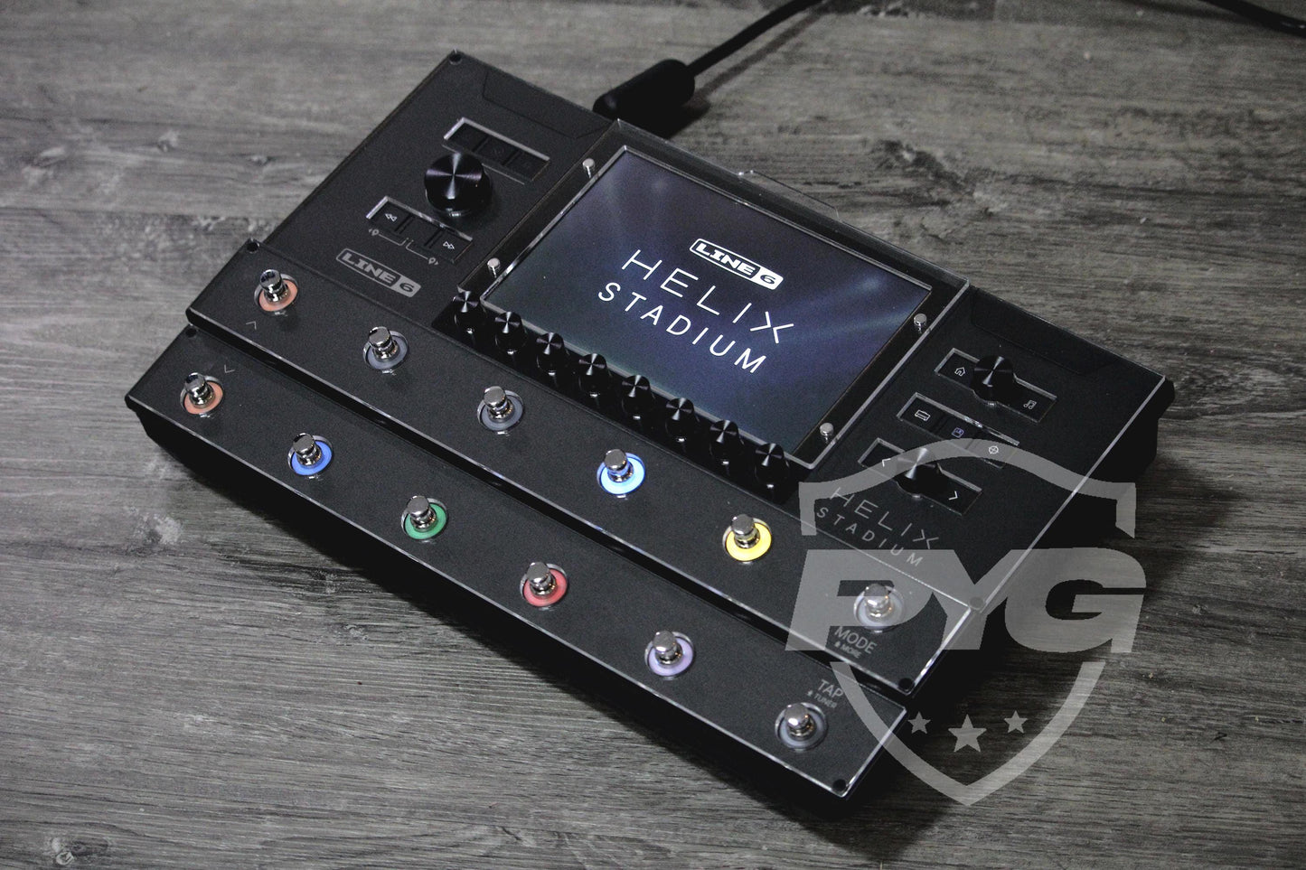 Line 6 Helix Stadium on a grey wooden surface with the clear acrylic ProtectYourGear shield fitted over the display and both footswitch rows