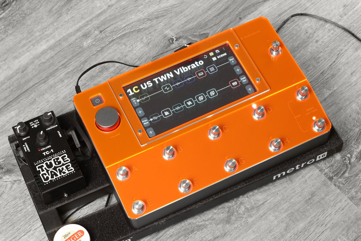 Neural DSP Quad Cortex with the neon orange ProtectYourGear acrylic shield on a pedalboard